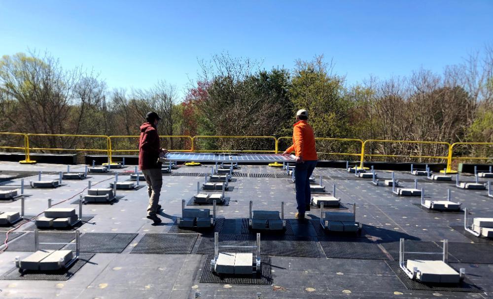 Solar panels being carried for install