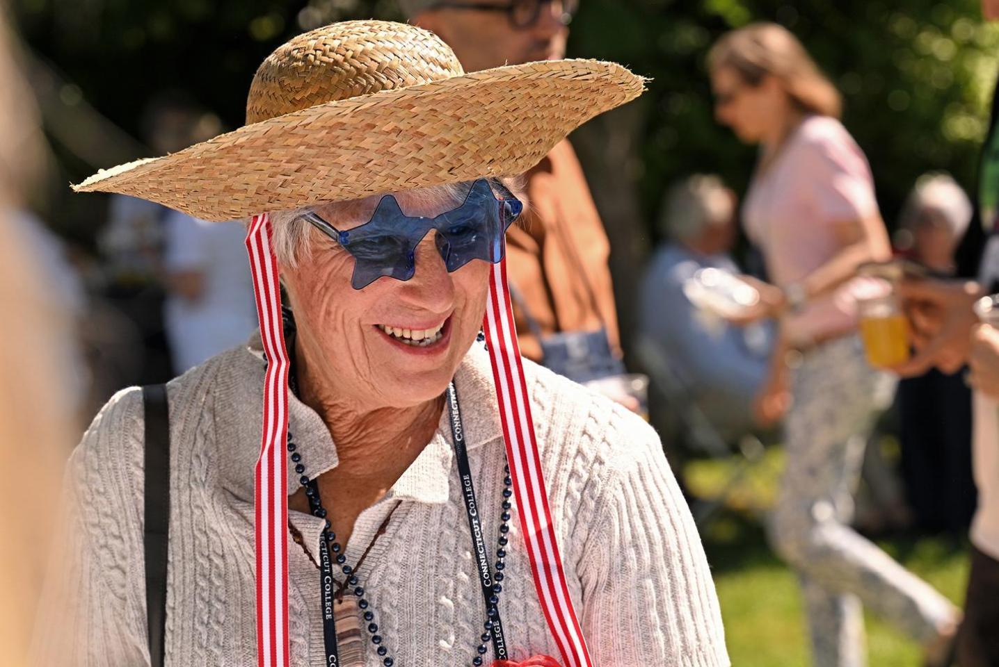 Alumn wearing a fun hat and glasses at Reunion 2024