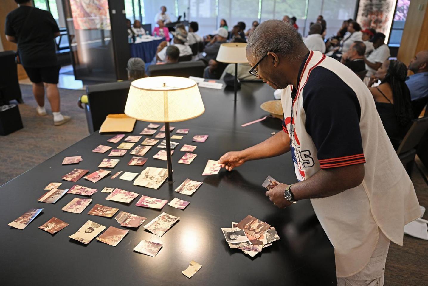 Alumni laying out photos at Reunion 2024