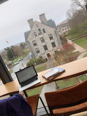 A photo taken from the study space on the upper floor of New London Hall showing the sidewalks below and Fanning Hall across the way