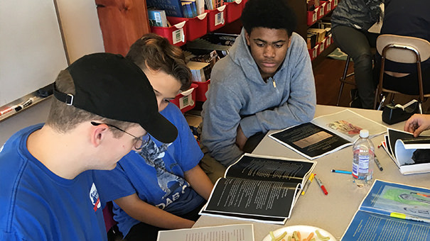 An Education Department student helps local school children with homework.