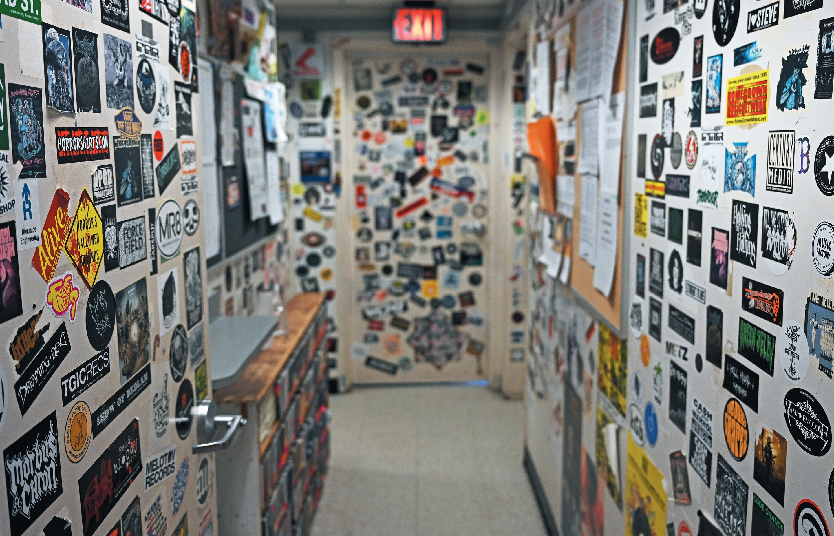 Hundreds of band stickers on the wall at WCNI
