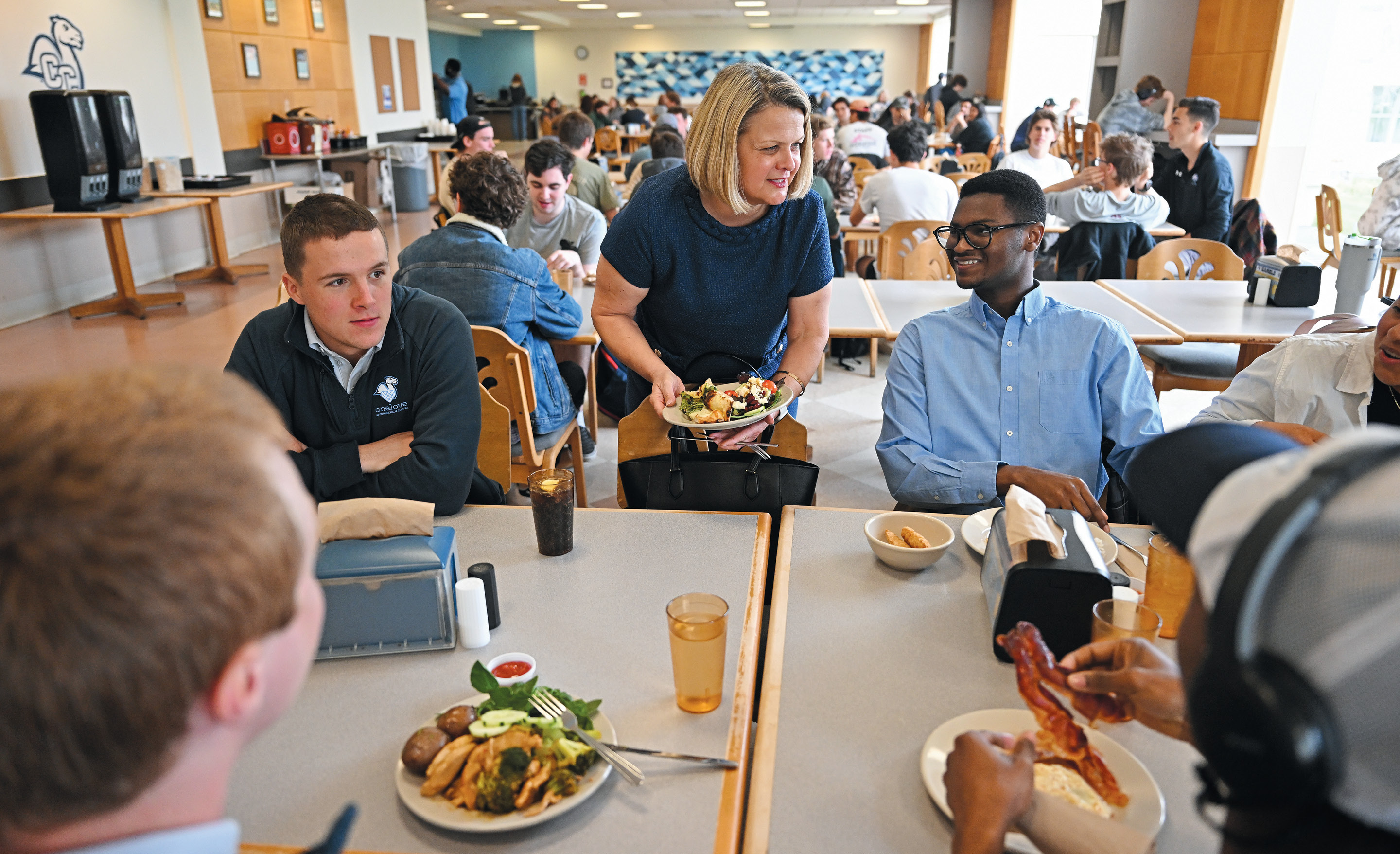 President-elect Andrea Chapdelaine talks with students at Harris Refectory.