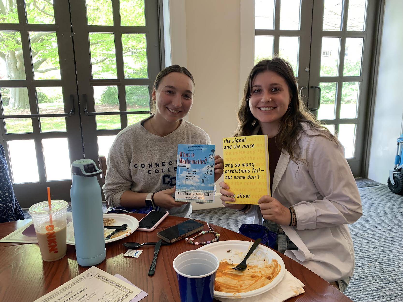 students holding books