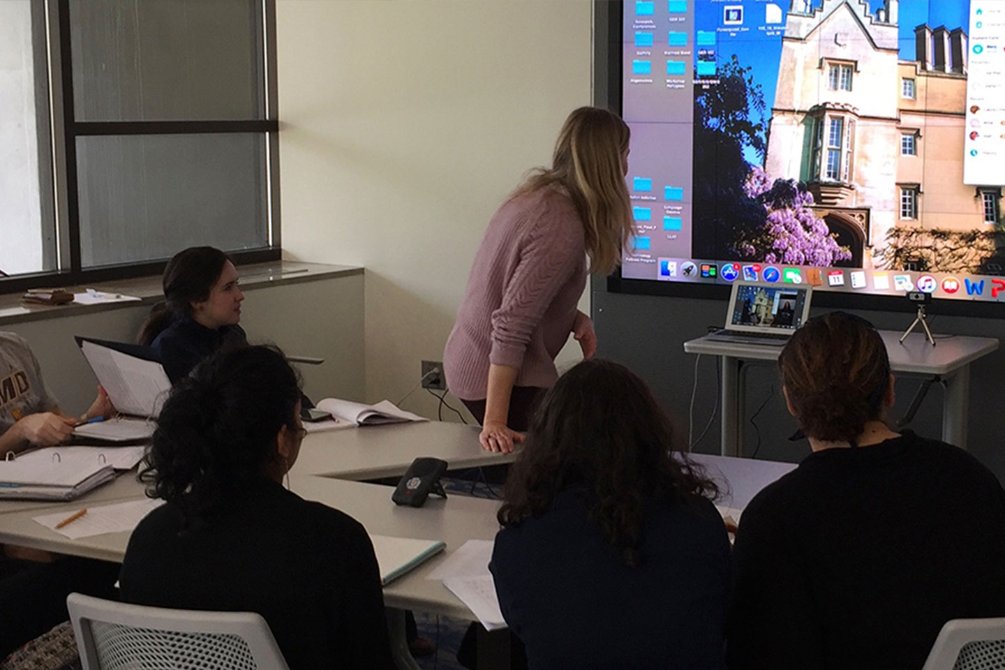 Students in a classroom videoconferencing with another classroom