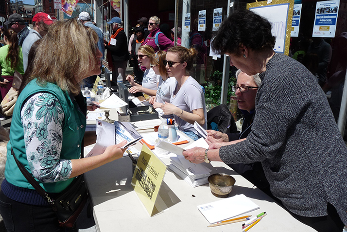 Connecticut College students and other volunteers help register walkers before the 11th annual Walk to End Homelessness. 