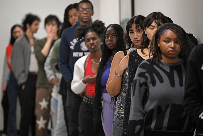 a line of students for a queue to practice their fashion show walk