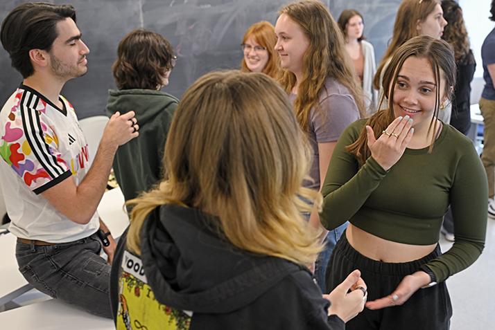 students communicate using American Sign Language in class